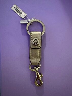 Coach Metallic Silver Leather Key Ring with Turnlock NWT never used.